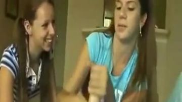 Promiscuous teen playing with a long cock while her friend watches