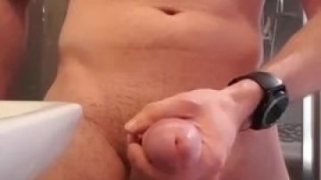 Muscular man jerking his cock off the table solo male